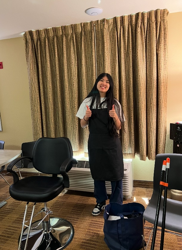 Founder Ava Zhang standing beside her salon chair
