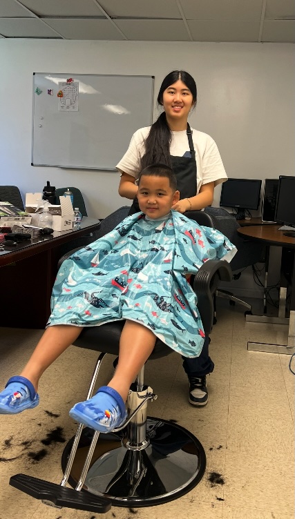 Ava and a young client after his haircut