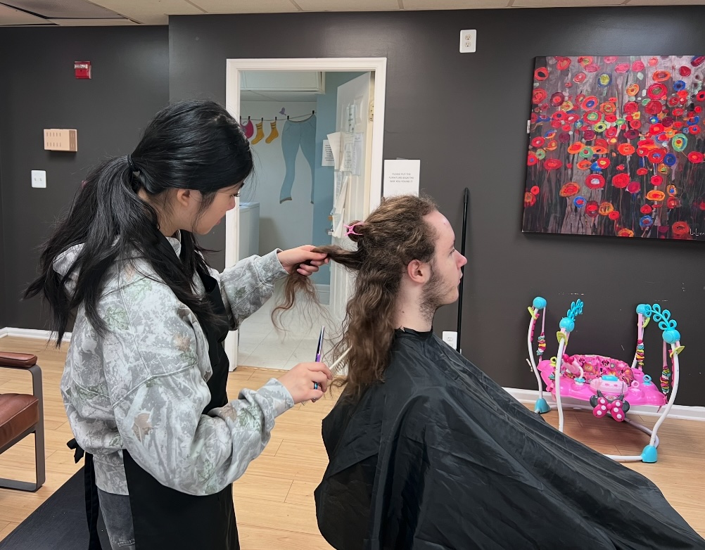 Ava cutting an adult client's long hair