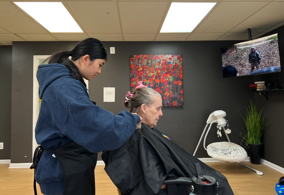 Ava styling an older woman's hair